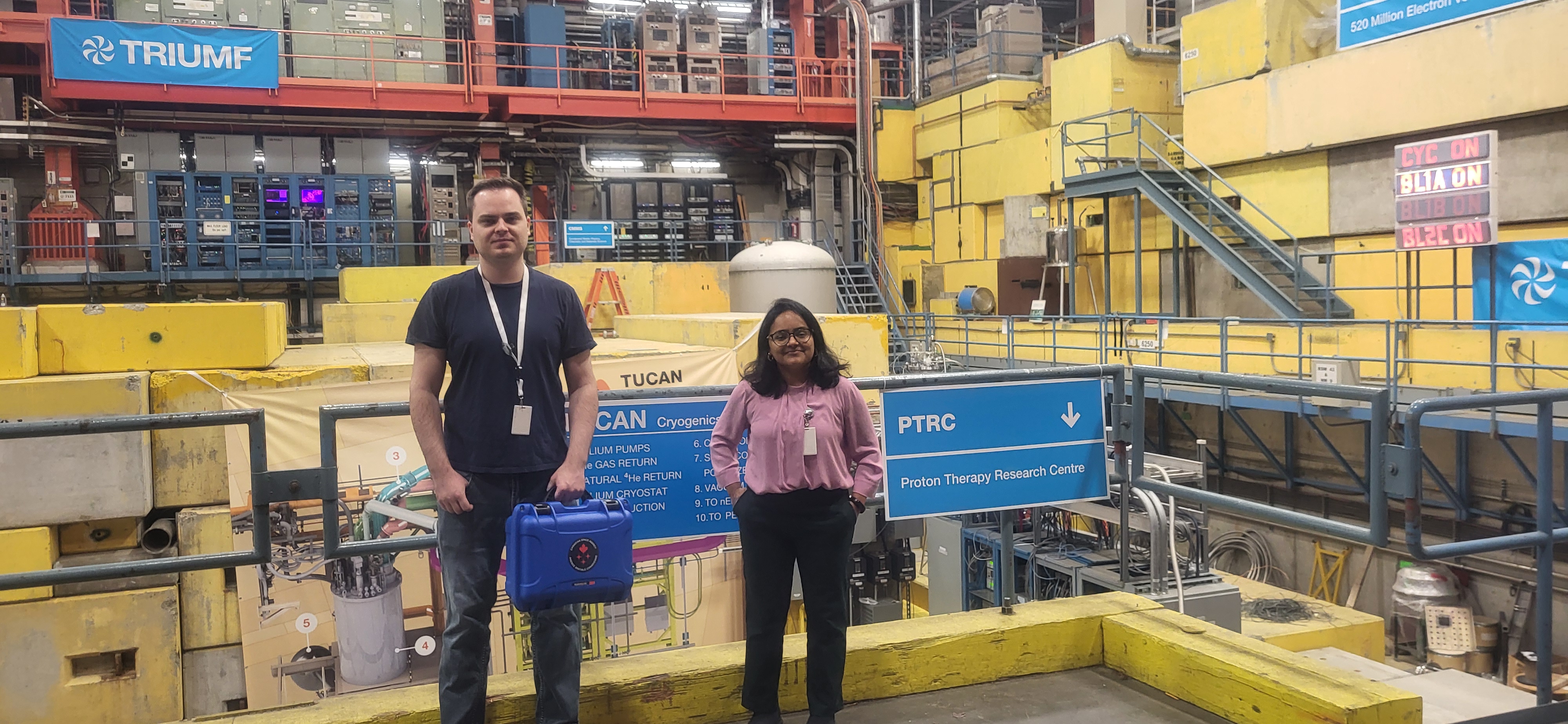 Two students in front of instrumentation